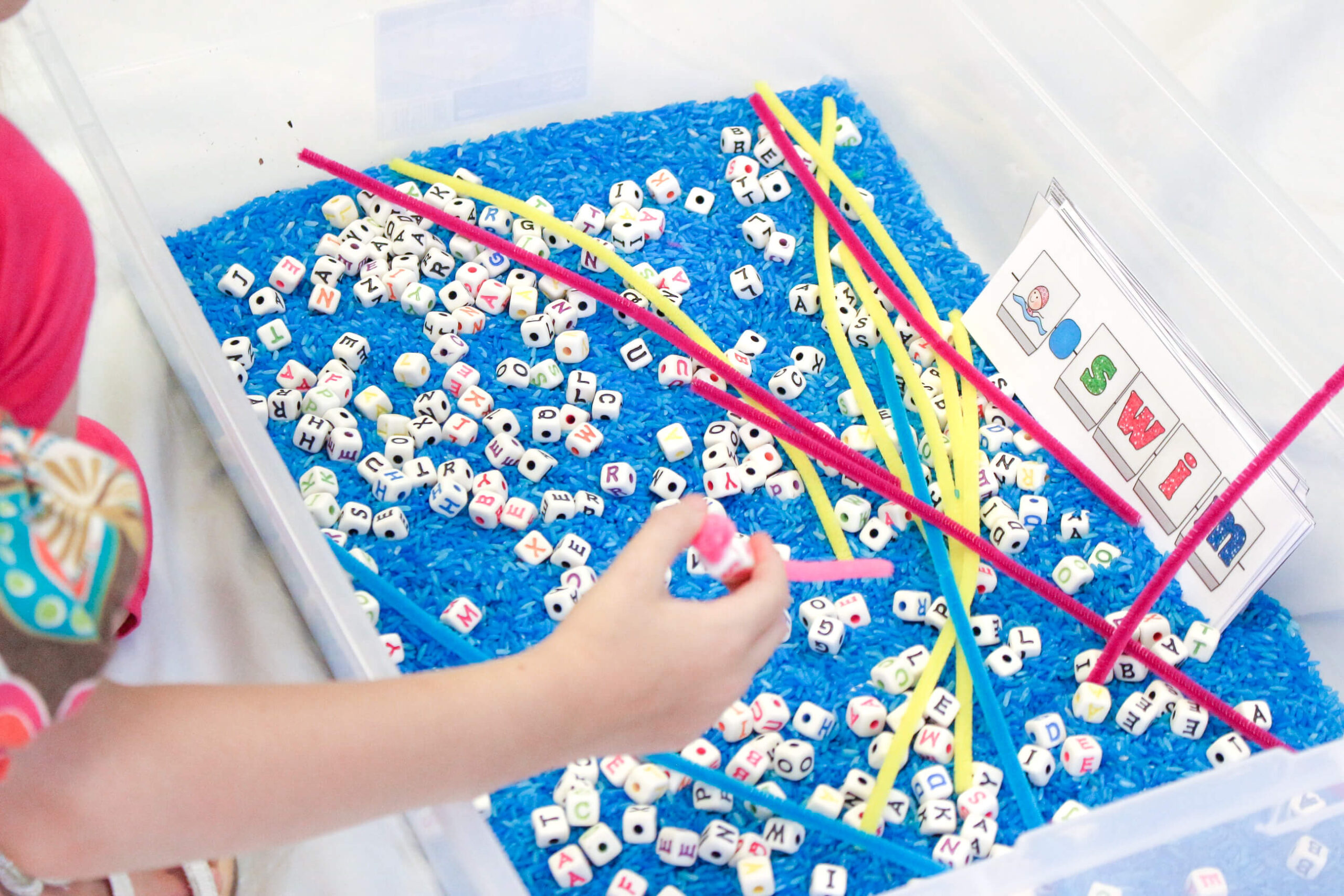 Alphabet beads word building practice in kindergarten