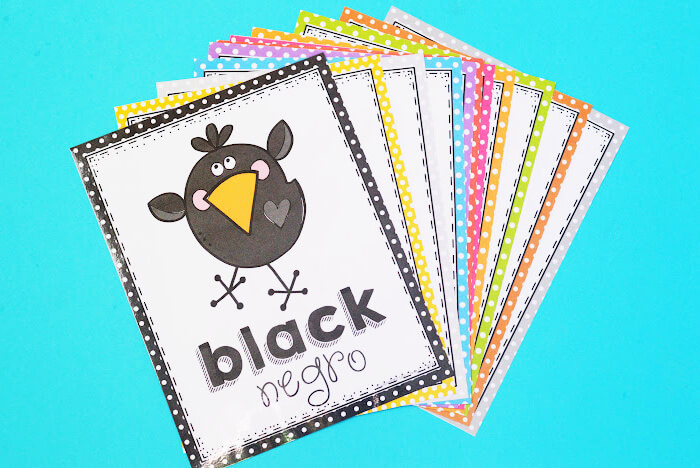 Early elementary learn English and Spanish colors posters with a black bird on a blue background.