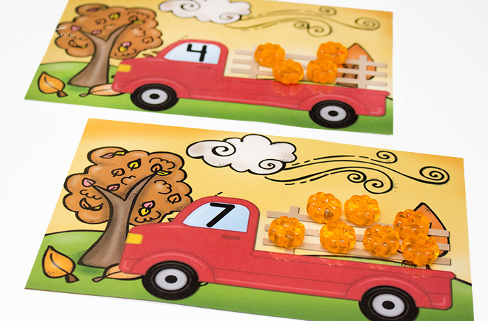 Place counters like mini plastic pumpkins on the counting cards to show the given number.