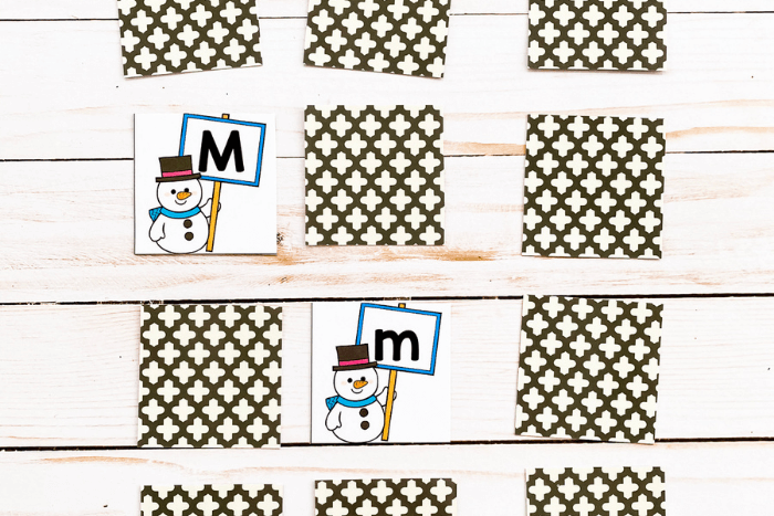 Alphabet matching cards laid out, showing letter Mm
